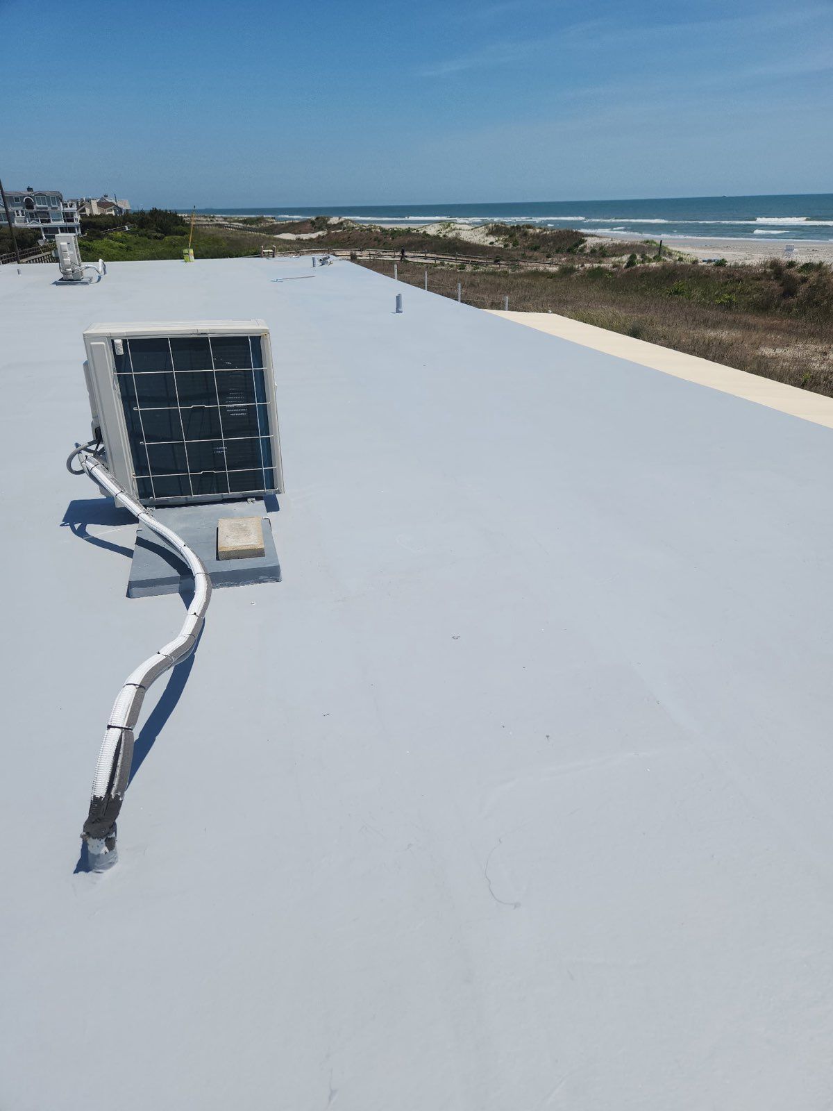 A solar panel is attached to the roof of a building