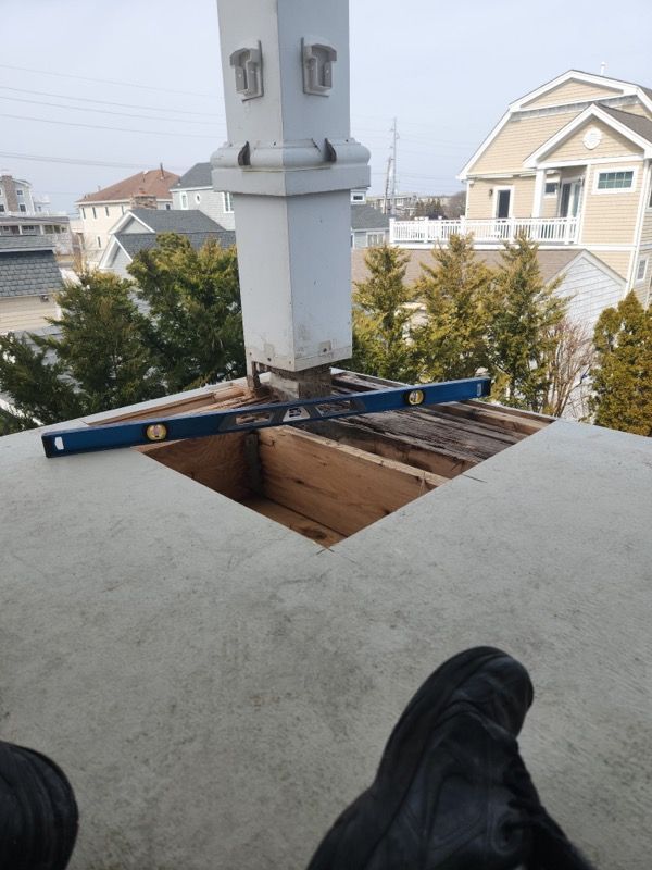 A person is sitting on a balcony with a blue level