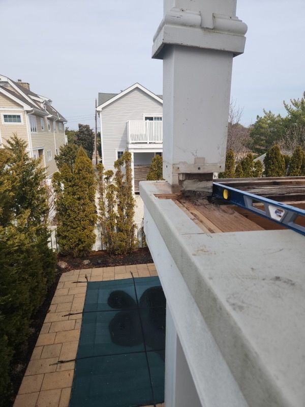 A blue level is on the roof of a house