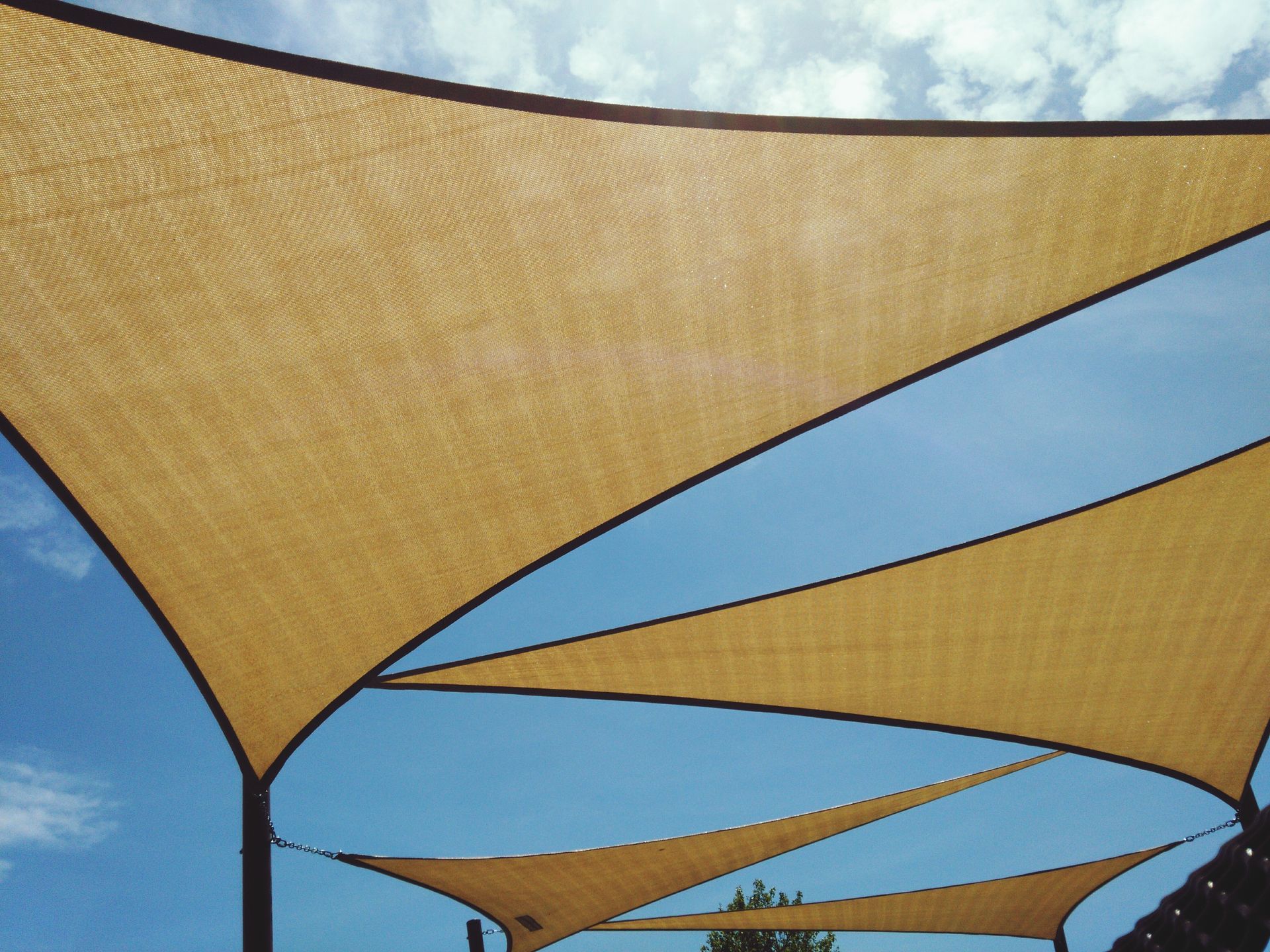 A row of shade sails against a blue sky | Cordova & Pasadena, MD | Shoreline Awning & Trim