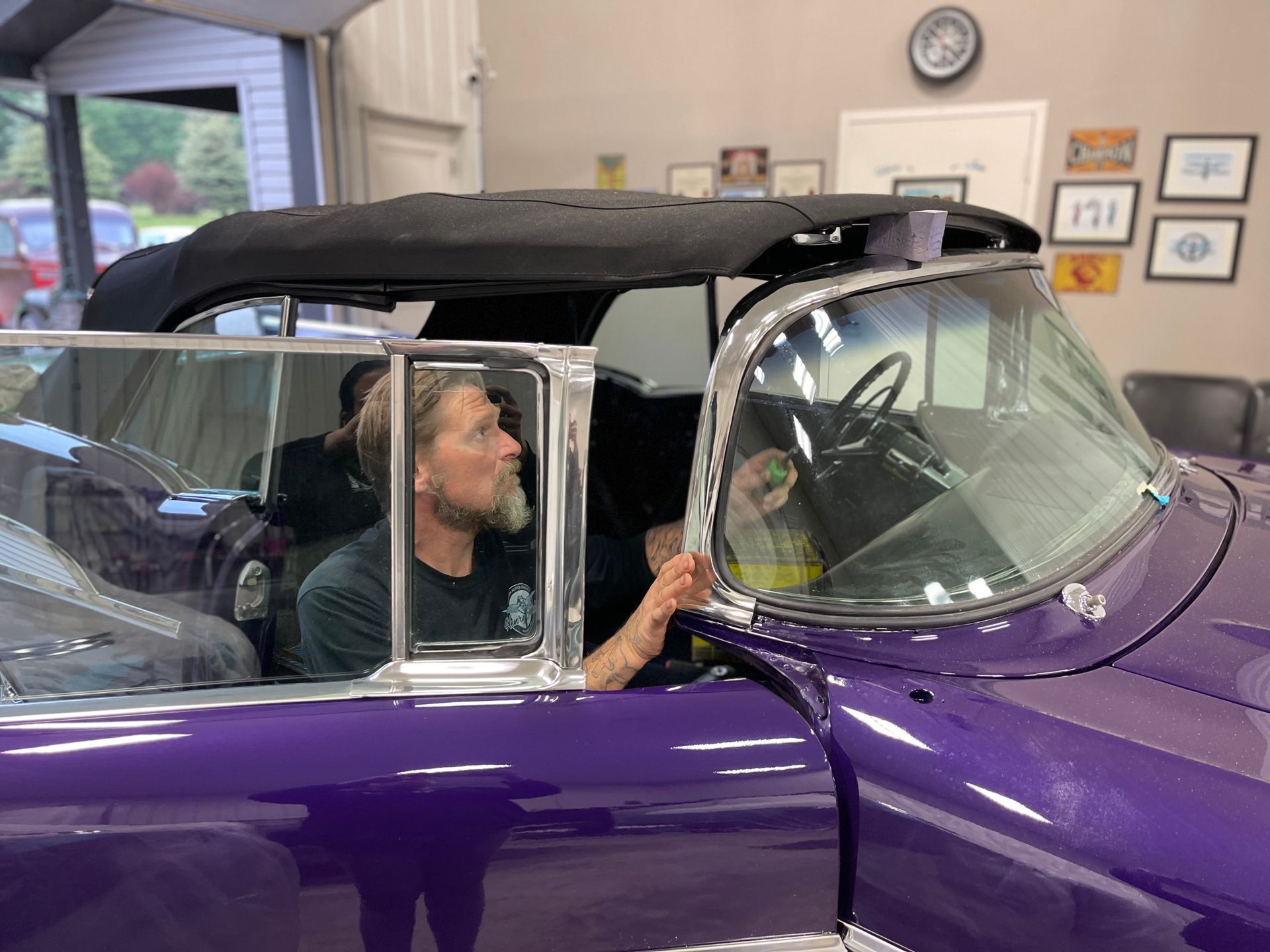 Man checking a polished purple car
