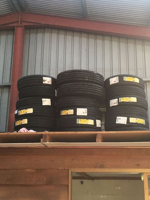 A Stack of Tires Sitting on Top of A Wooden Shelf — Fletcher's Truck and 4WD Repair Centre in Forster, NSW