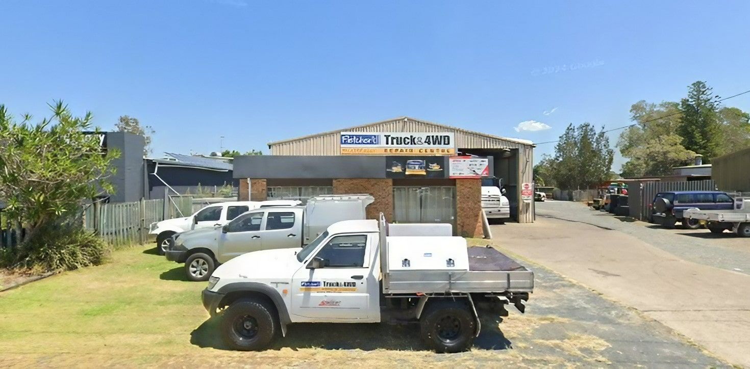 A White Truck Is Parked in Front of A Building — Fletcher's Truck and 4WD Repair Centre in Forster, NSW