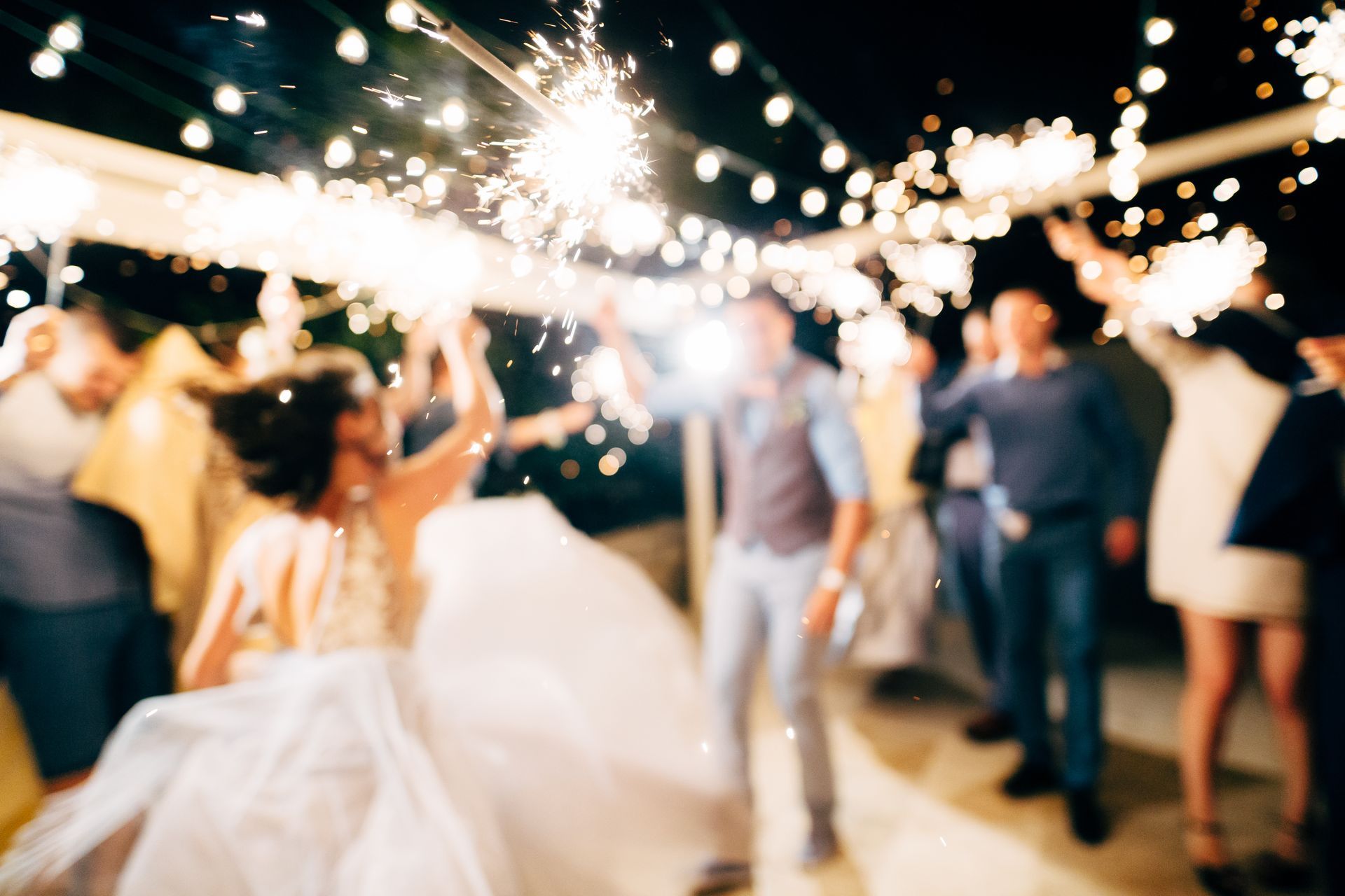A close-up of the sparkler against the backdrop of the party.