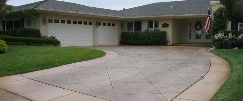 A large house with a large driveway leading to it