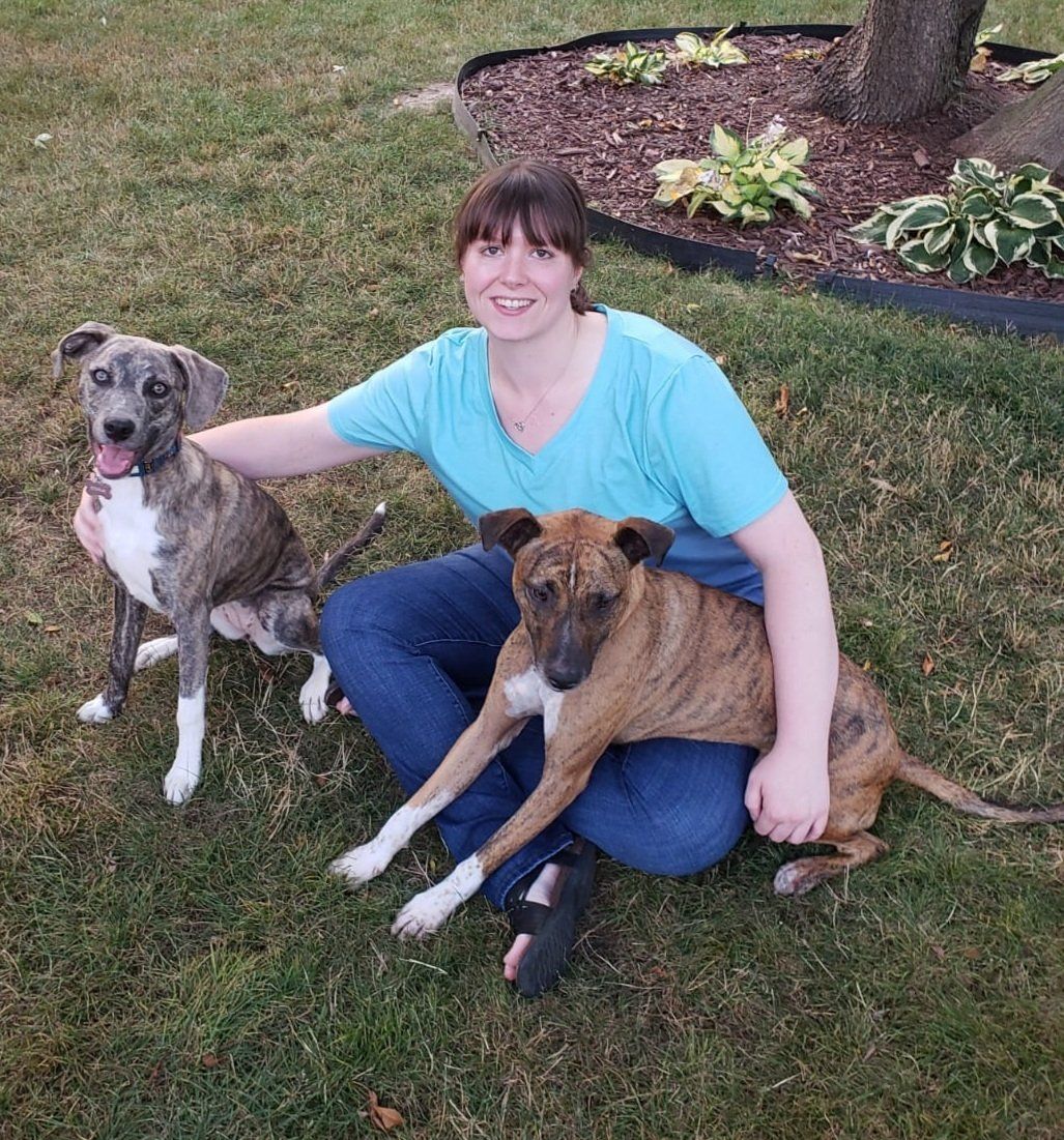 Ashley Blahnik —  With 2 dogs sitting on garden in Lake Forest, IL