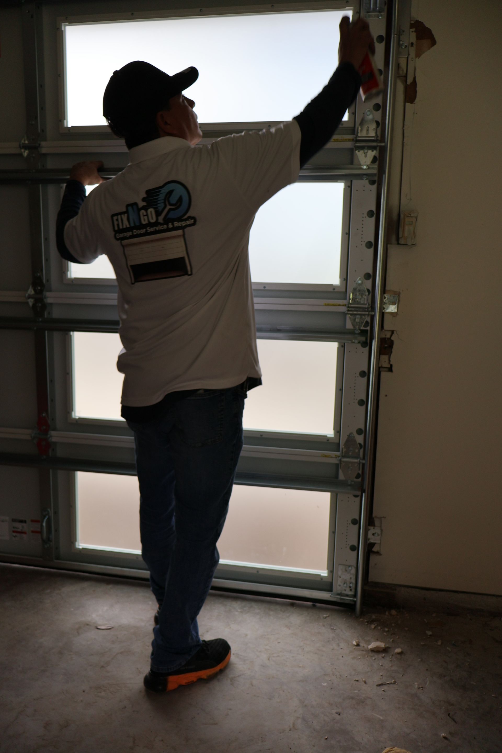 a man on a ladder fixing the opener 