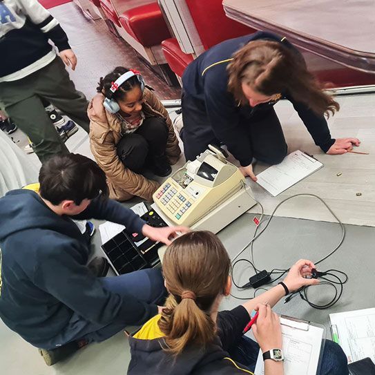 Workshop participants investigating a simulated crime scene.