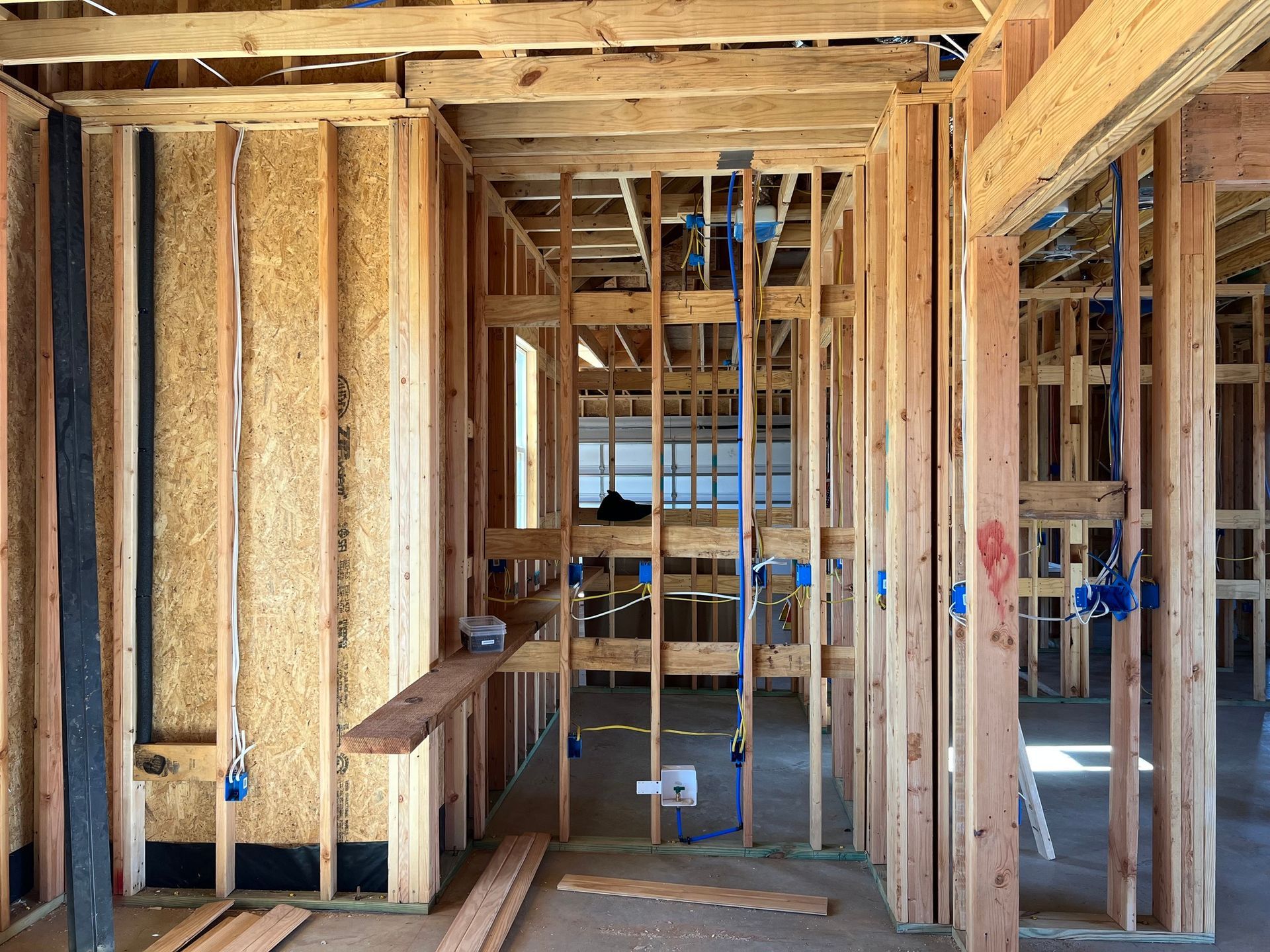 Electrical wiring inside a breaker box: blue, brown, yellow, and green wires connected.