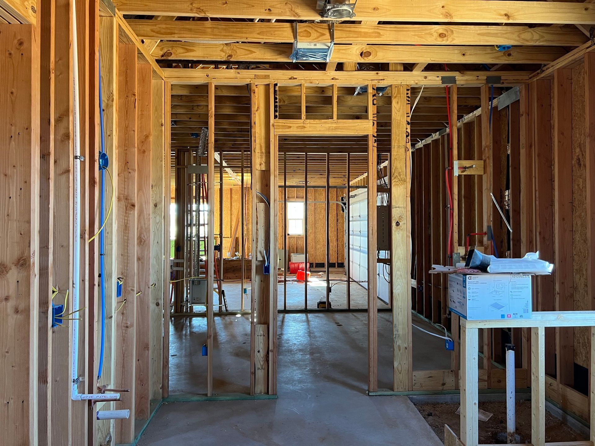 A person uses a multimeter to test electrical wiring in a breaker box; a close-up shot of hands and tools.