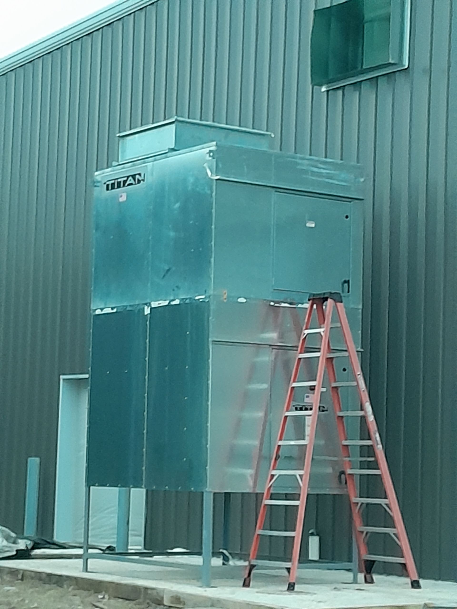 A car is sitting inside of a paint booth.