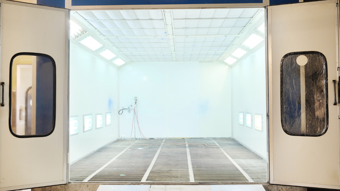 An empty paint booth with the doors open.