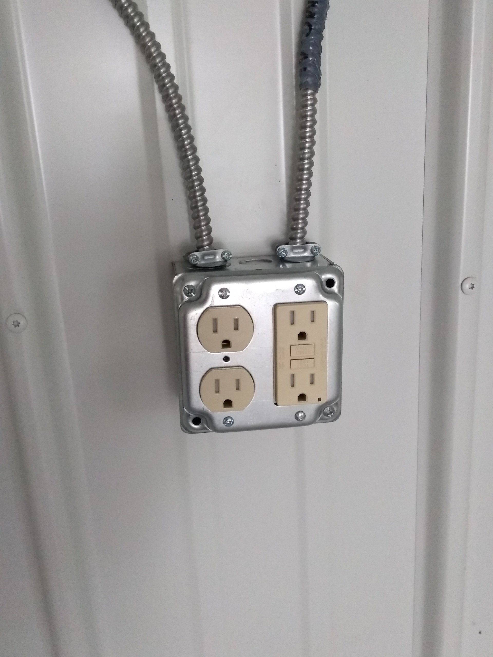 two electrical outlets on the wall .