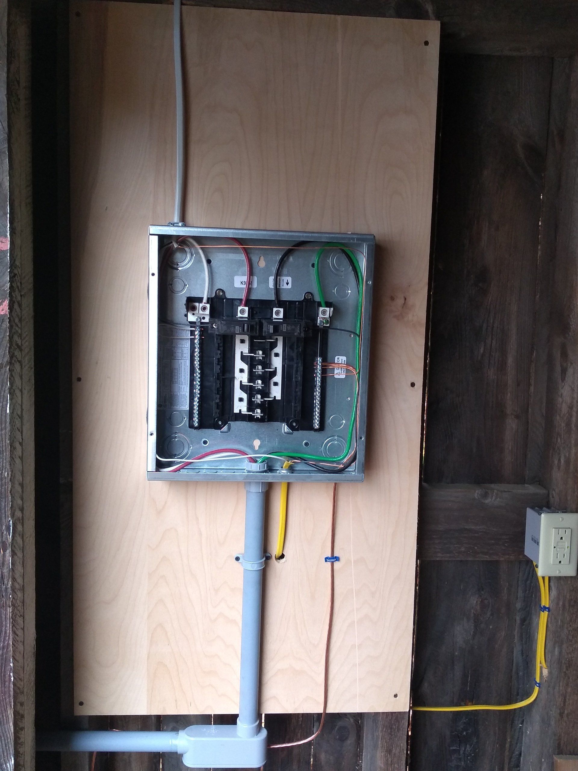 a electrical box mounted on a wooden wall.