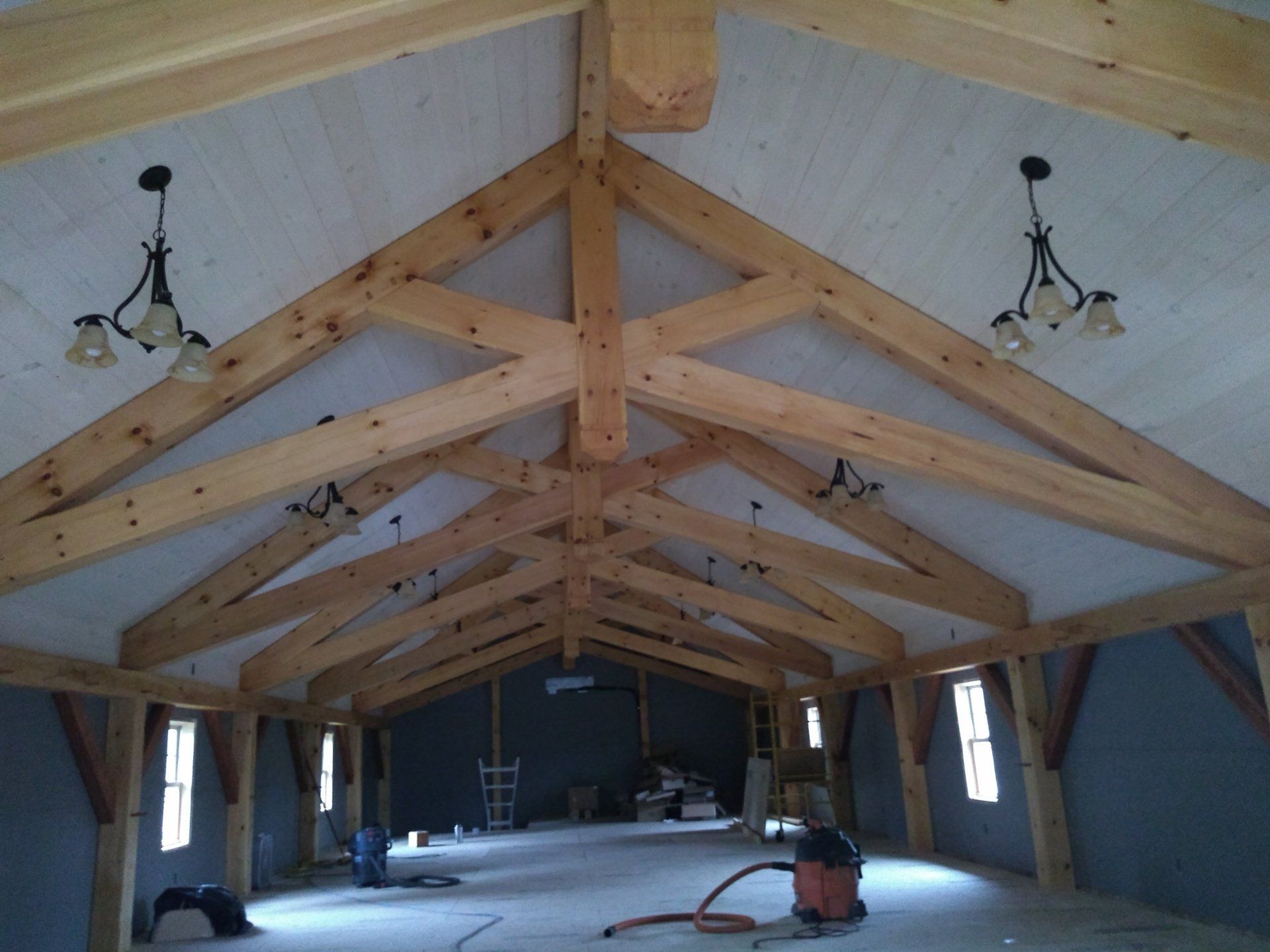a large room with a vaulted ceiling and wooden beams