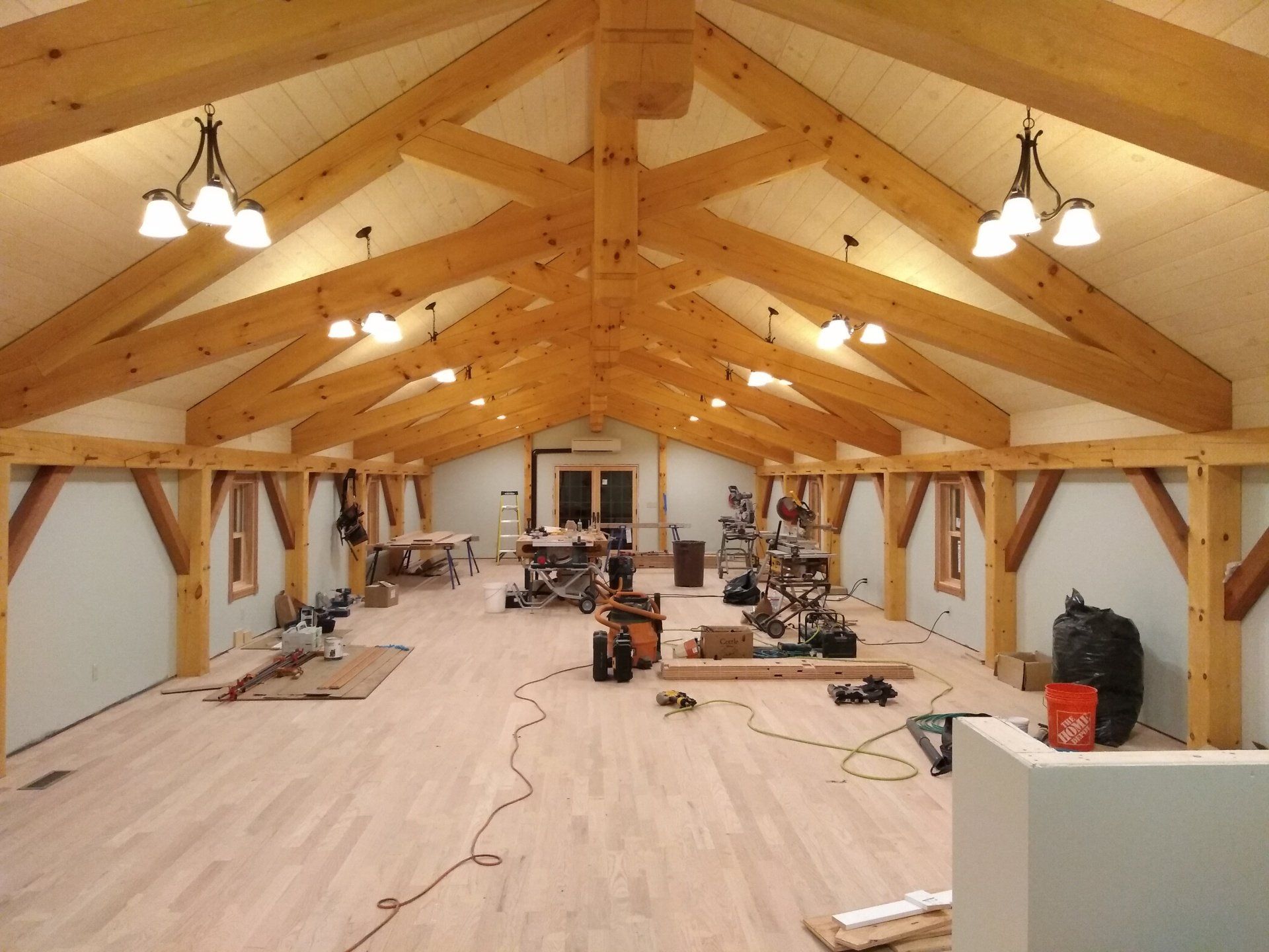a large room with a vaulted wooden ceiling and bright lights
