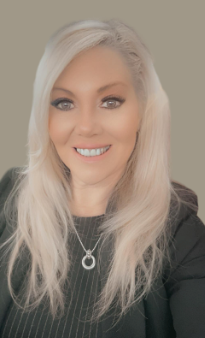 A Woman Is Standing In An Office With Her Arms Crossed And Smiling - Lexington, VA - Drewniak Nicks Legal Defense PLLC