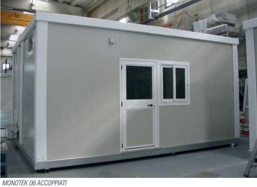 Un grande edificio bianco con due finestre e una porta.