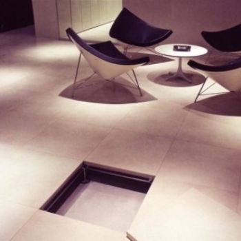 Una stanza con sedie e un tavolo con un buco nel pavimento