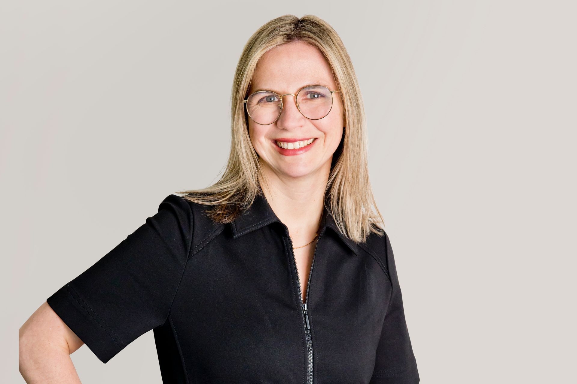 A person wearing blue gloves is holding a yellow pen