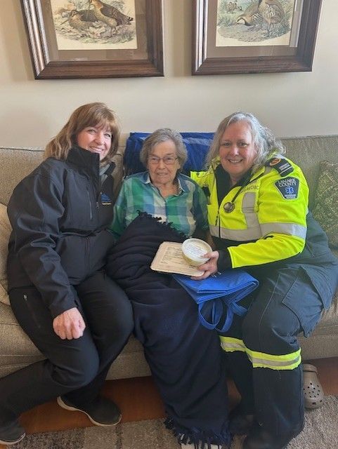 A man is rolling dough with a rolling pin in a kitchen.
