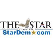 The logo for The Star Democrat, featuring the newspaper name in black text with an eagle, and a blue URL with a star.