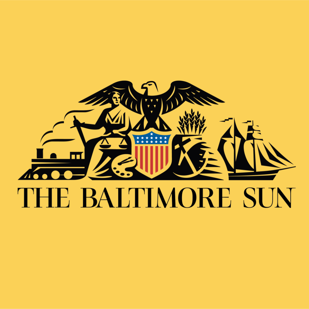 The Baltimore Sun logo: a crest with a central shield, eagle, ship, train, and agricultural tools on a yellow background.