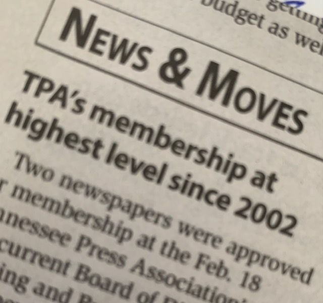 A close-up of a printed newspaper headline reading 