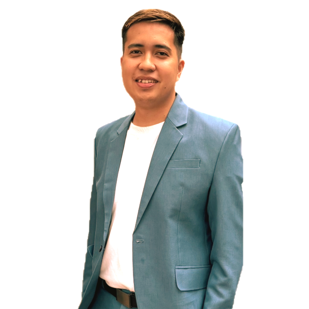 A smiling person wearing a blue suit jacket over a white shirt against a plain white background.