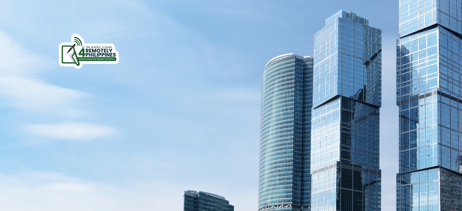 Tall modern glass buildings against a clear blue sky.