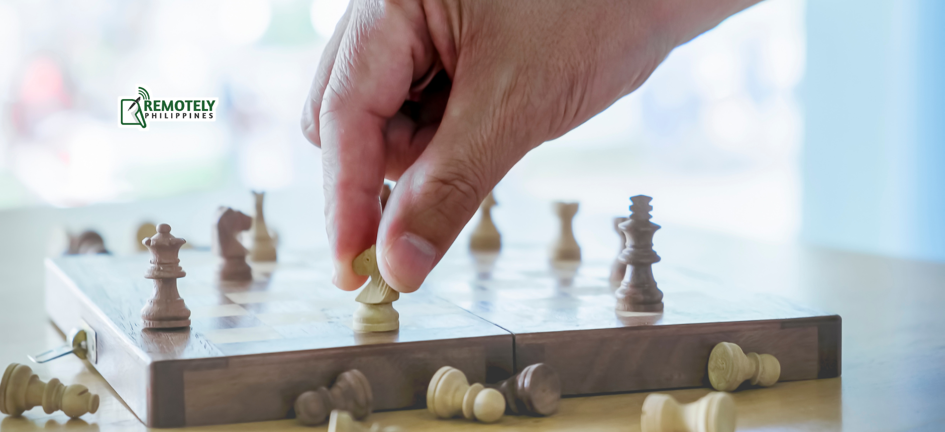 A person is playing a game of chess on a wooden board.
