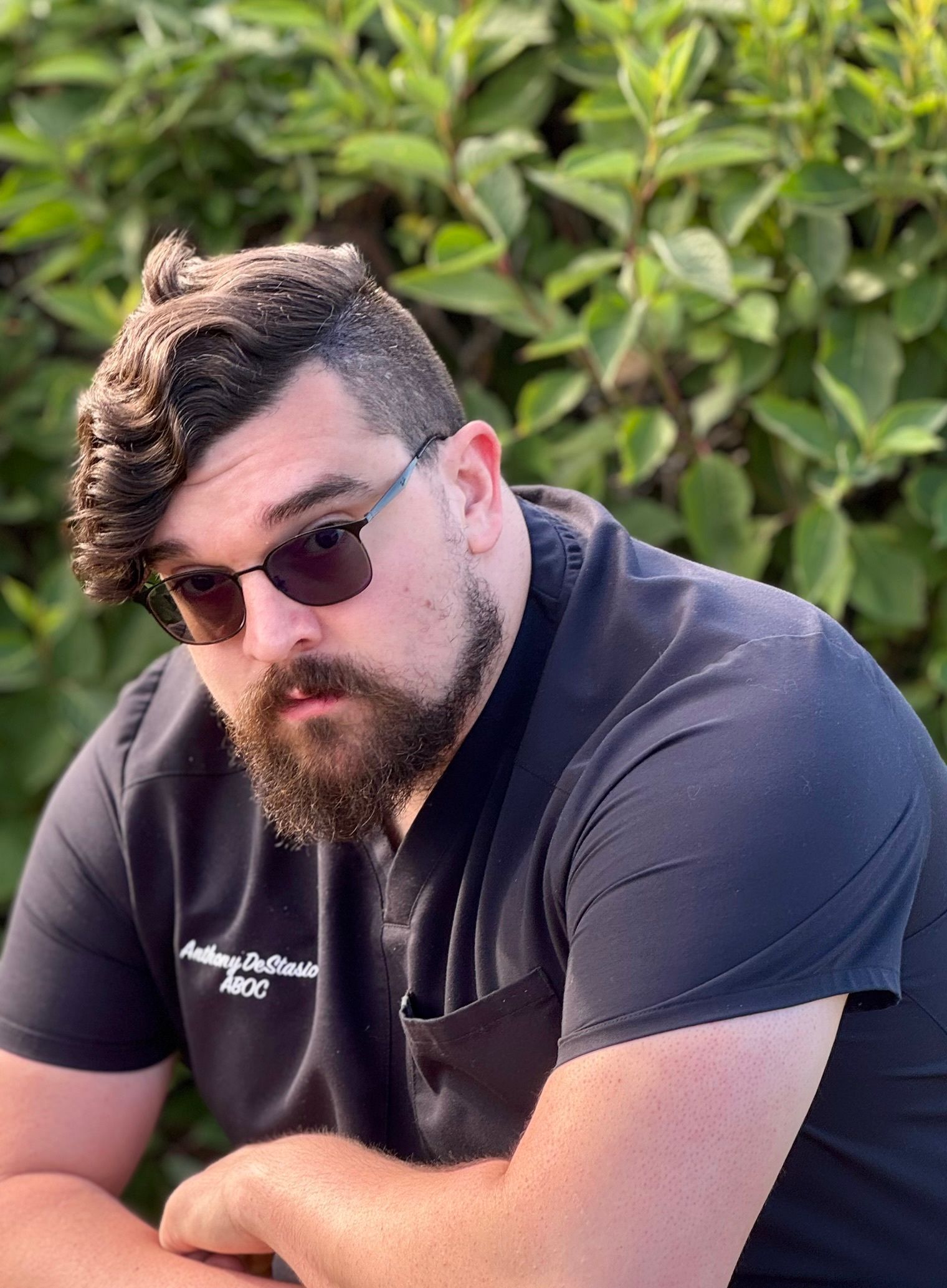 A woman is sitting in a chair with her hand on her chin.