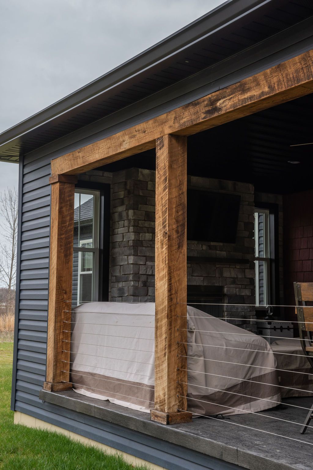 A large window on the side of a house with a hot tub in the background.