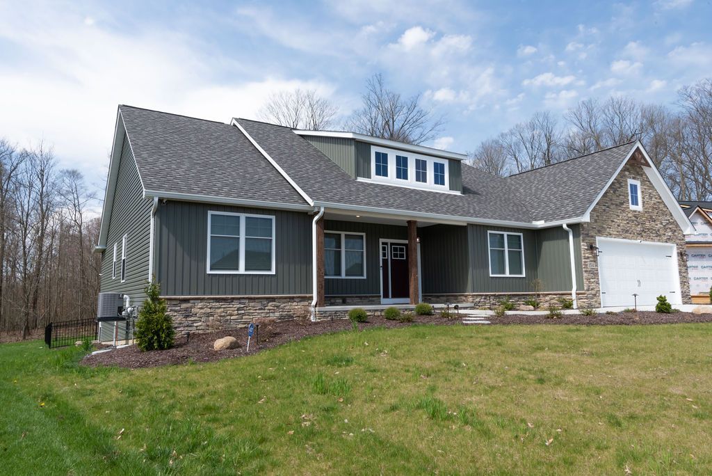 A large house with a large lawn in front of it.