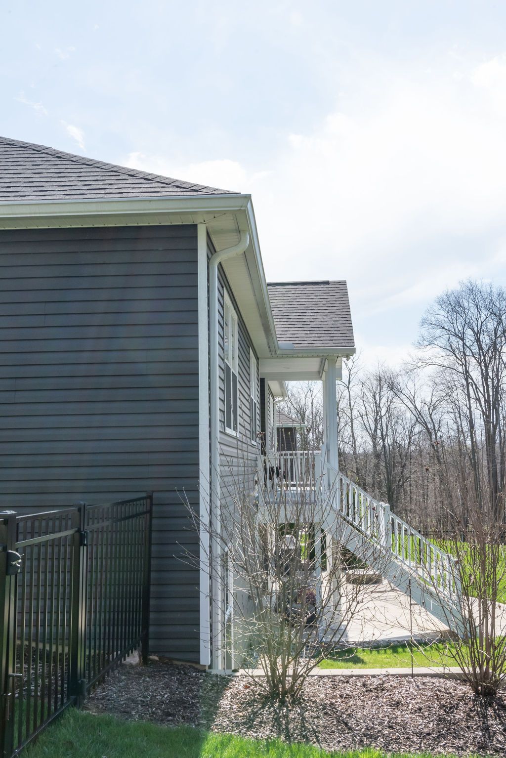 The side of a house with a porch and stairs.