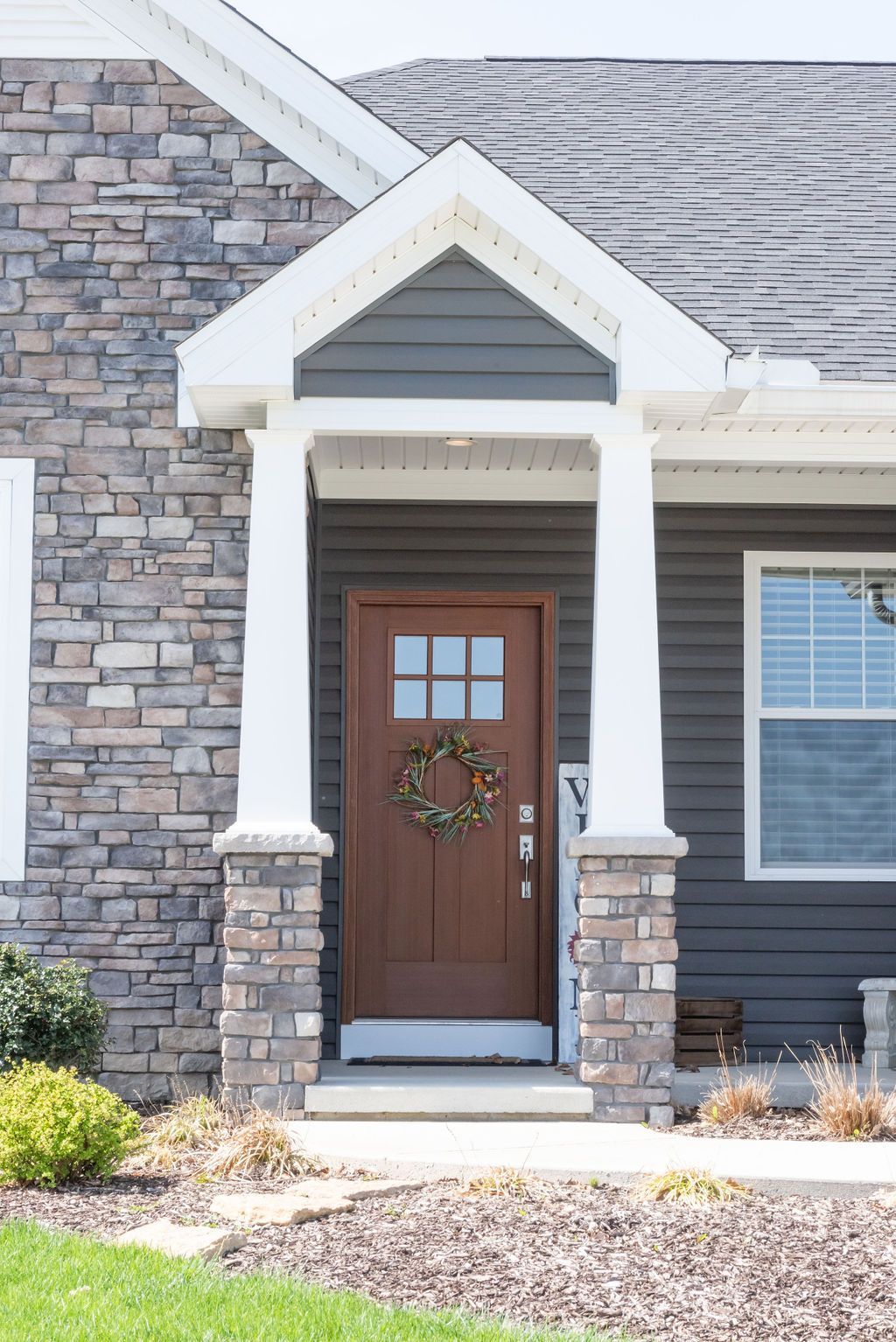 The front door of a house with a wreath on it.