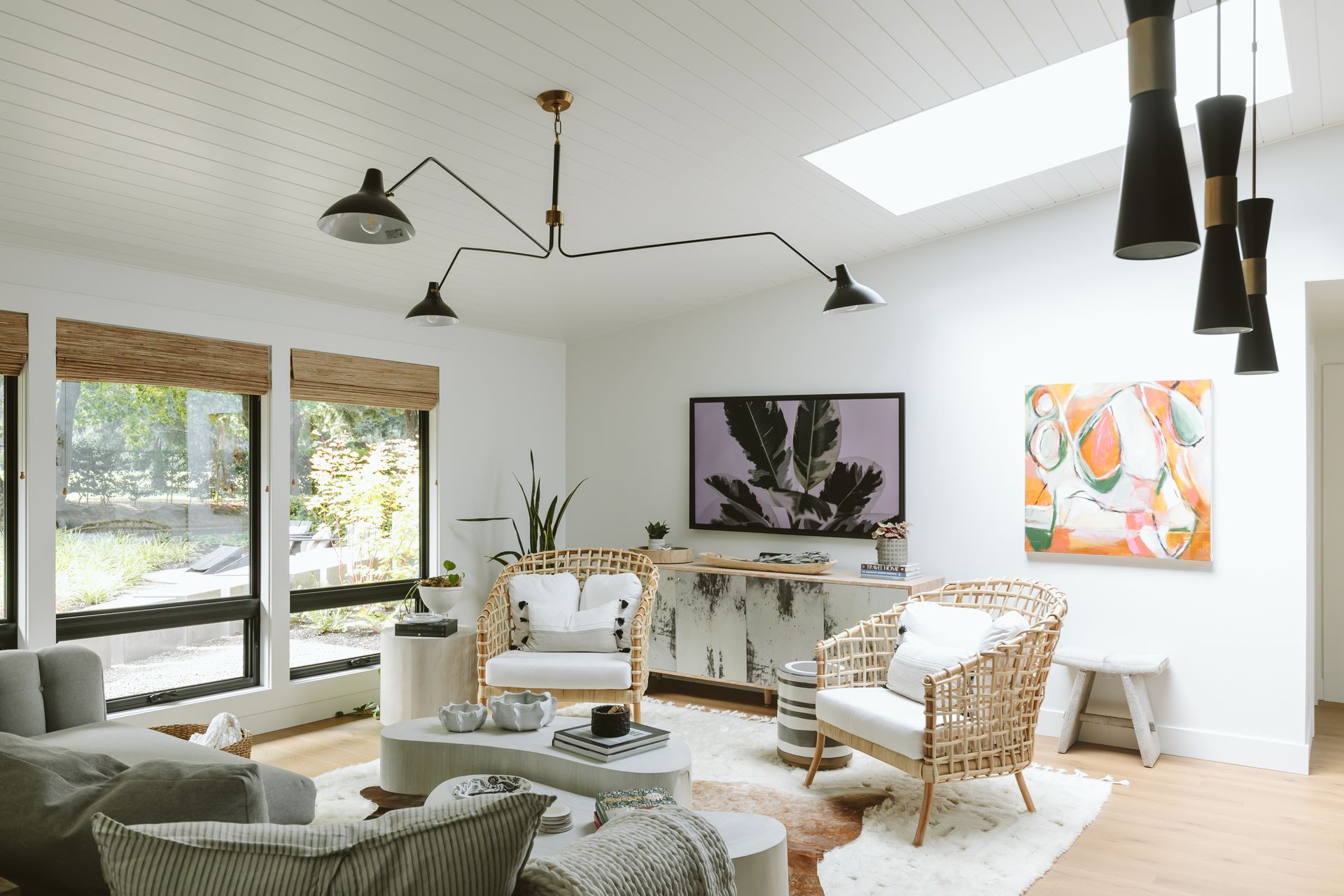A living room filled with furniture and a skylight.