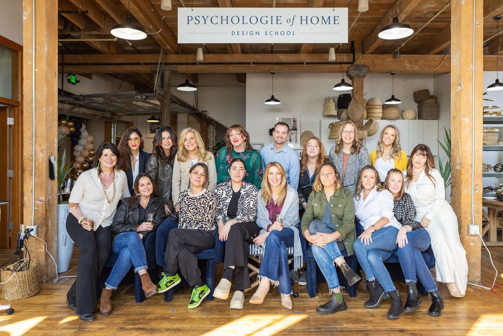 A group of people are posing for a picture in a room.