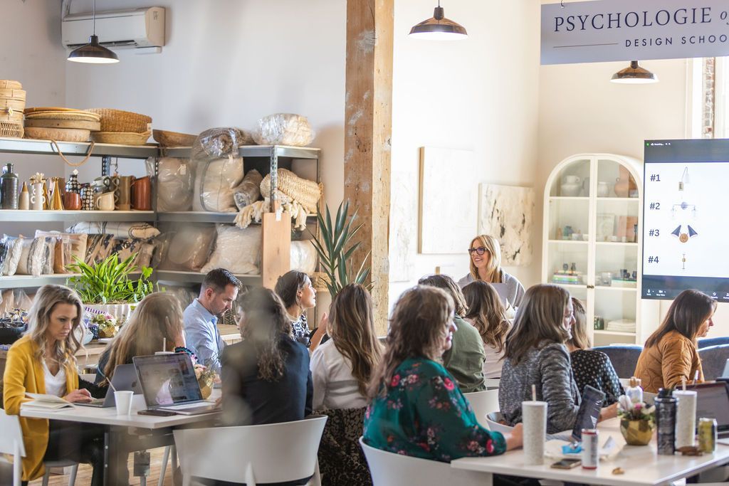 A group of people are sitting at tables in a room.