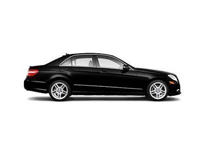 Client being assisted with luggage by a driver during a private transfer