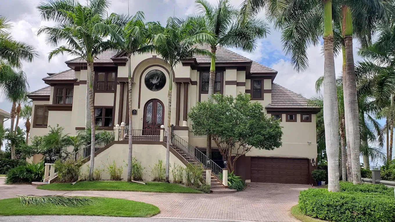 A large house with a ladder on the side of it.