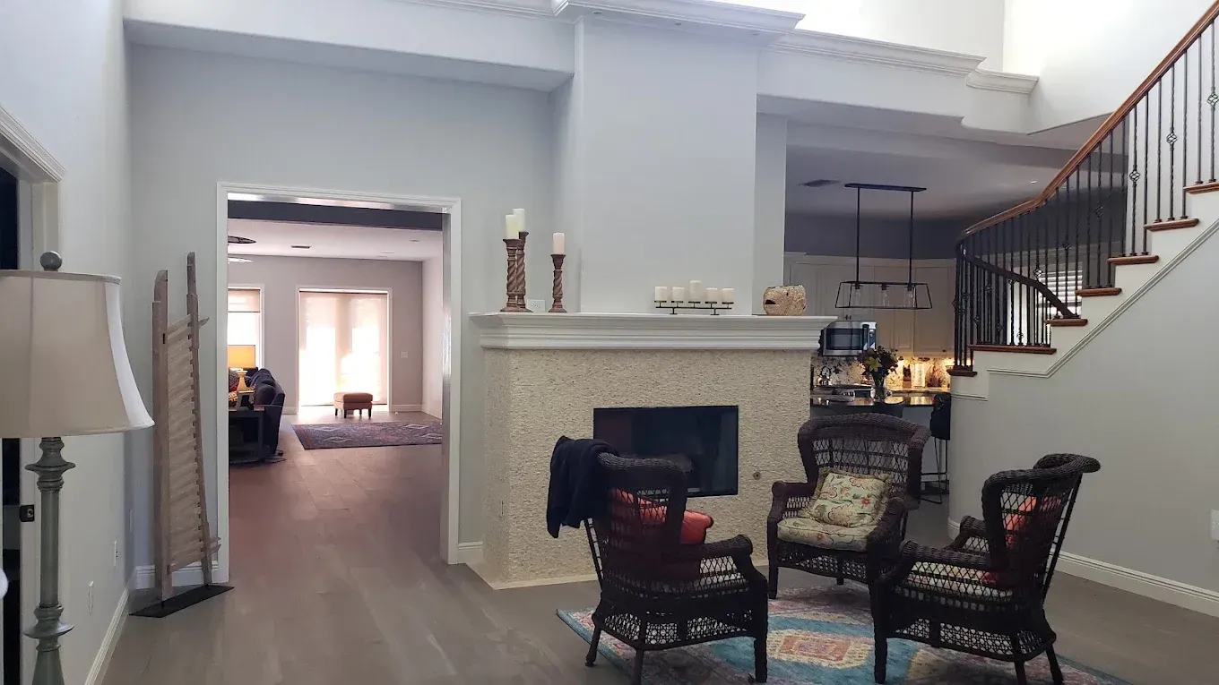 A kitchen with white cabinets and a large island in the middle.