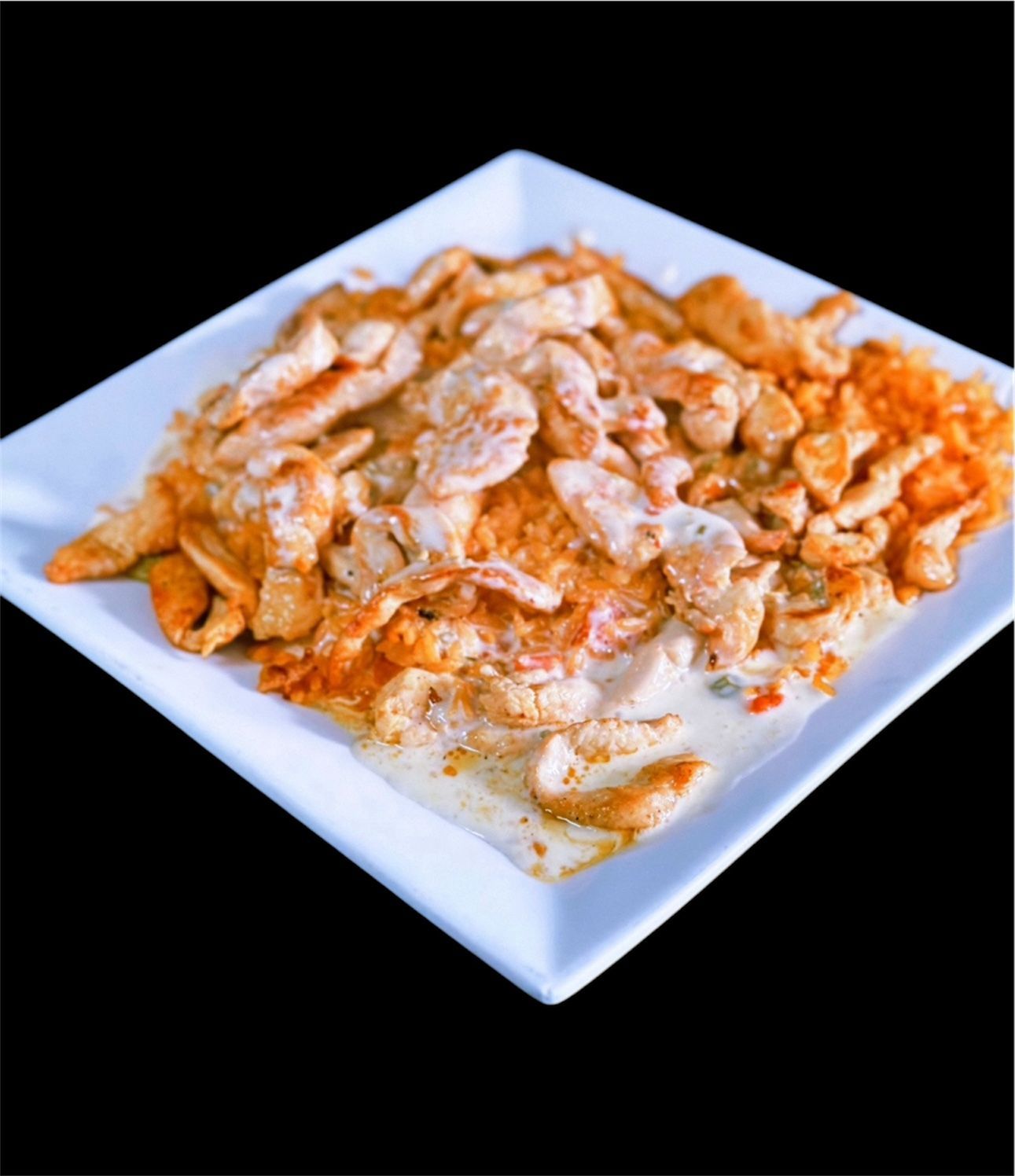 A white plate topped with chicken and rice on a black background.