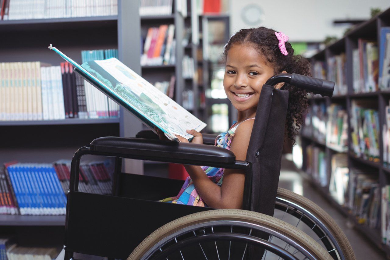 Little Girl On Wheelchair At Library — Luray, VA — Rodger L. Smith, Counselor at Law, PC