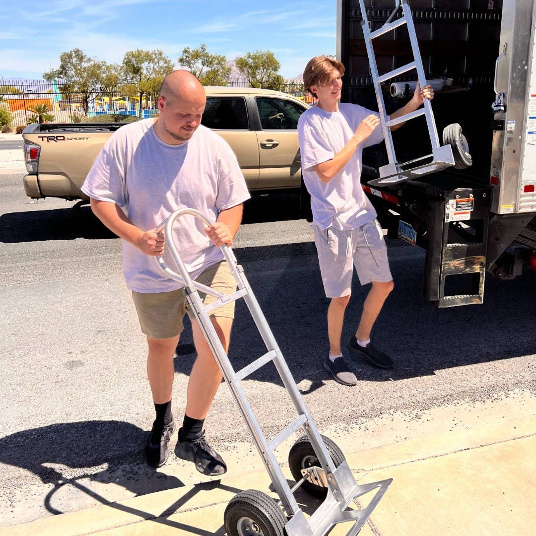 Two men and a truck with dollies and moving equipment in Las Vegas, NV