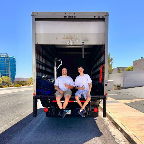 Three movers with dollies and boxes