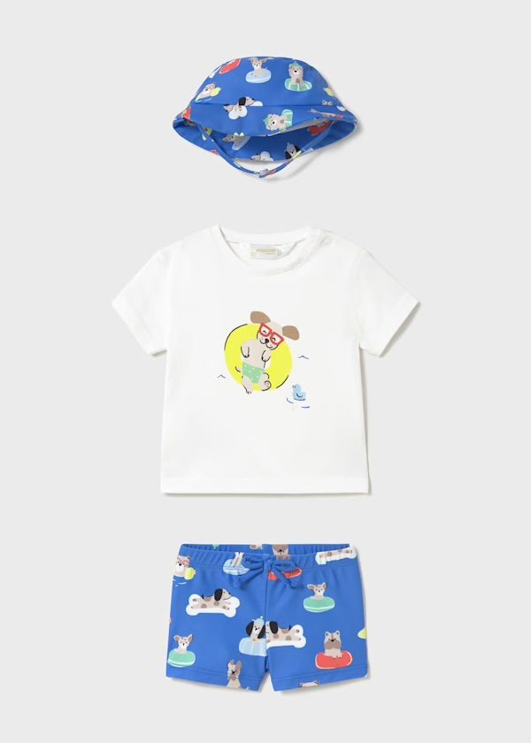 Completo blu per neonato con cappello, maglietta bianca con stampa di un cane e costume da bagno.