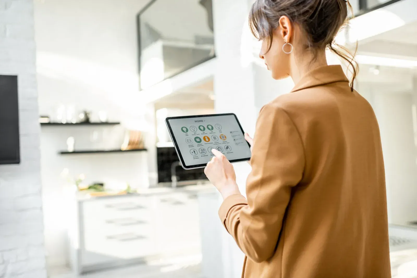 A woman is using a tablet in a living room.