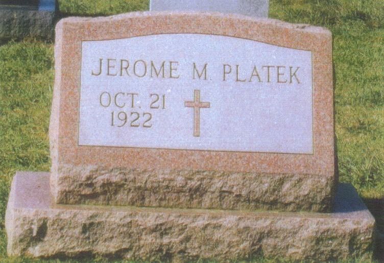 Headstone of Jerome M. Platek, with name and birth date (October 21, 1922) and a cross.