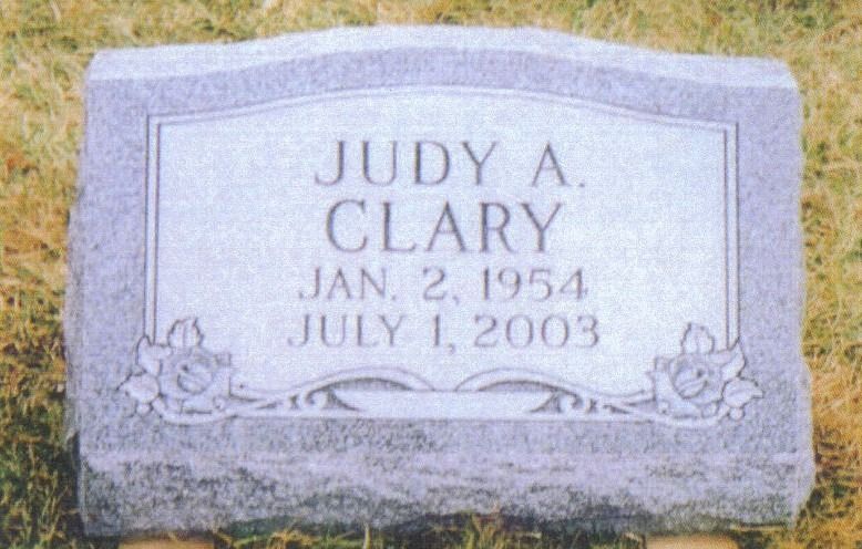 Headstone for Judy A. Clary, born January 2, 1954, died July 1, 2003. Gray stone with floral designs.